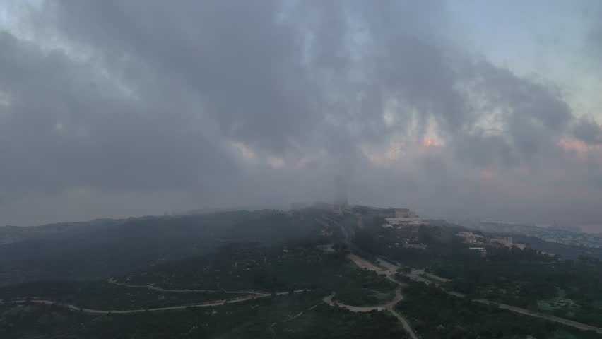 Mount Carmel, located in the city of Haifa, at a misty sunrise from a drone view