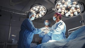Medical team high-fiving after successful surgery in the operating room, celebrating their success. A diverse group of doctors and nurses, working together. Medical Team High-Fiving After Surgery - Powered by Shutterstock - Get 15% off with code: PIKWIZARD15