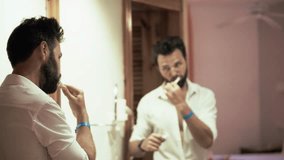 Man Brushing Teeth In Bathroom Mirror. Morning Hygiene Routine Daily Personal Care. Oral Hygiene Daily Habits Self-Care Ritual. Clean Teeth Dental Care Morning Routine. Hygiene Products Brushing Teeth - Powered by Shutterstock - Get 15% off with code: PIKWIZARD15