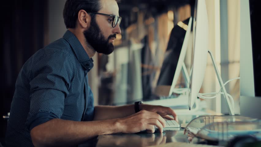 Man In Glasses Working At Computer. Corporate Office Productivity. Graphic Designer Business Strategy Concentrated. Corporate Career Financial Analysis Project Management. Data Entry And Analysis 