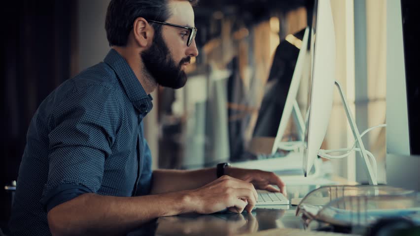 Man In Glasses Working At Computer. Corporate Office Productivity. Graphic Designer Business Strategy Concentrated. Corporate Career Financial Analysis Project Management. Data Entry And Analysis 