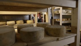 Family sightseeing in a cheese storage in countryside