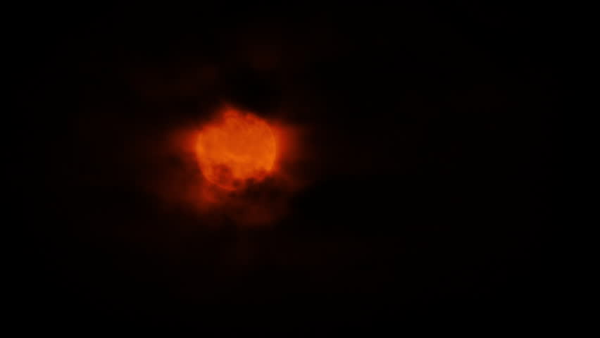 Red Moon With Dark Clouds Passing
