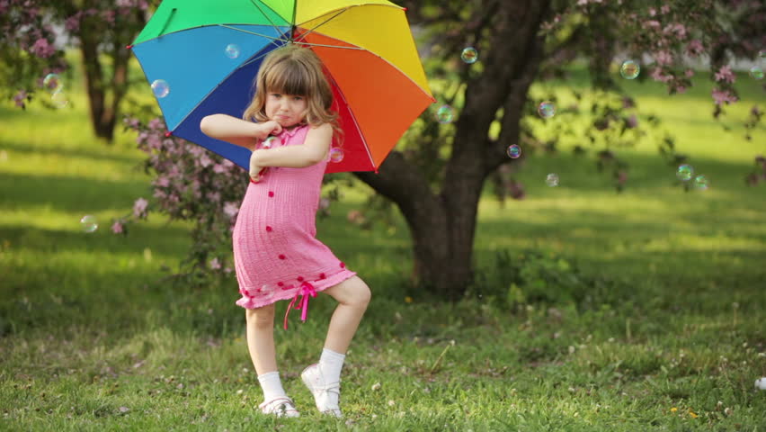 Little girl with umbrella smiling
