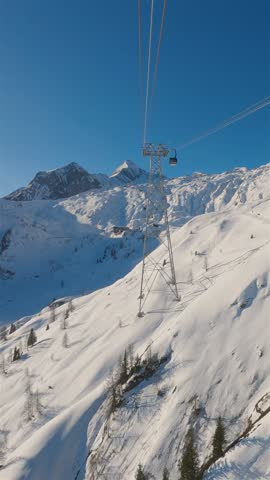 Vertical view of Gondola Ride to Kaprun Glacier in Winter Alps Ski Resort