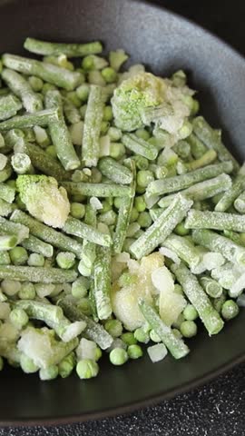 Frozen green vegetables green peas, broccoli, string beans, kohlrabi kale tasty snack fresh food background on the table rustic food top view copy space keto and paleo diet vegan and vegetarian food