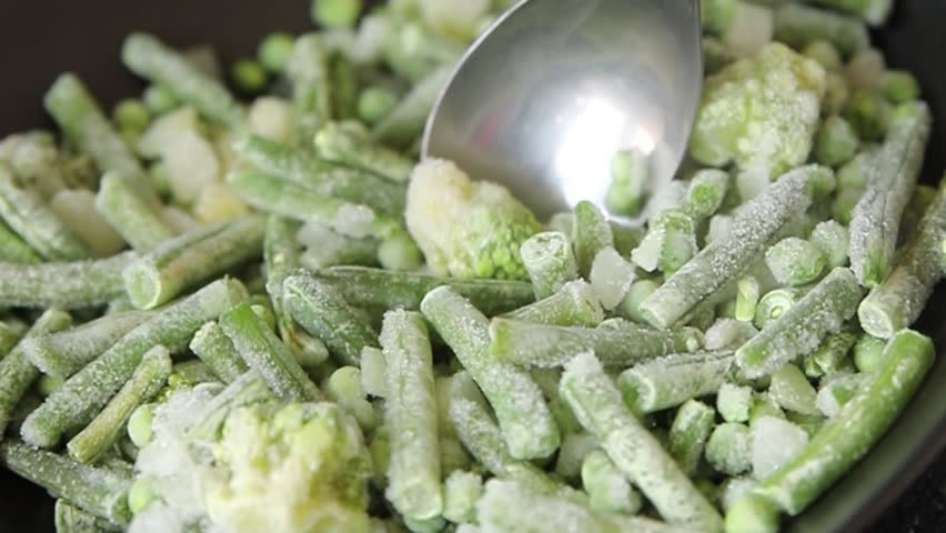 Frozen green vegetables green peas, broccoli, string beans, kohlrabi kale tasty snack fresh food background on the table rustic food top view copy space keto and paleo diet vegan and vegetarian food