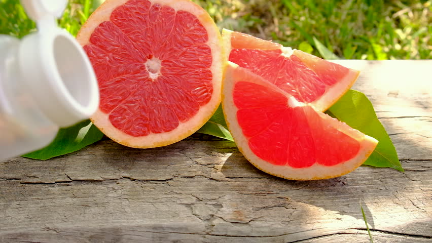 grapefruit essential oil in a bottle. Selective focus.