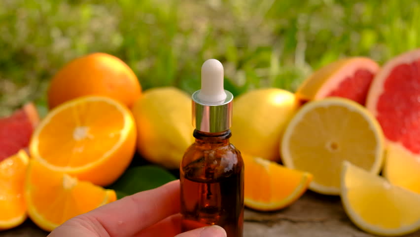 citrus essential oil in a bottle. Selective focus.