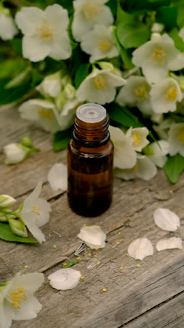Jasmine essential oil and flowers. Selective focus.