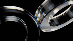 Iridescent glass rings rotating with elegant precision, revealing mesmerizing light reflections against deep black background while creating seamless geometric motion - Powered by Shutterstock - Get 15% off with code: PIKWIZARD15