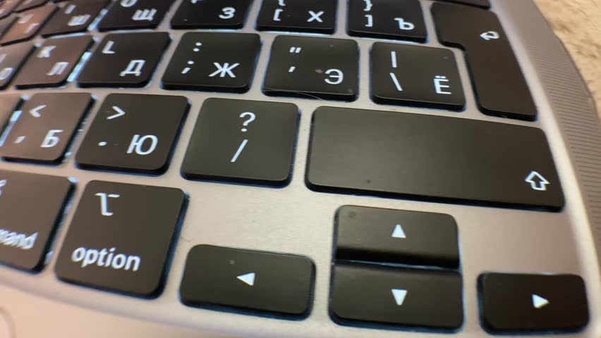 Close up of a laptop keyboard with smooth camera movement across the keys. Modern technology background, digital workspace, and computer equipment concept.