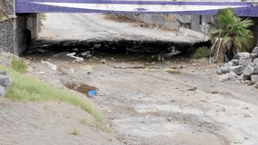 Neglected and Abandoned Underpass Filled with Litter and a Dry Streambed - Powered by Shutterstock - Get 15% off with code: PIKWIZARD15