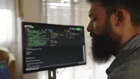 Professional programmer working simultaneously on desktop computer and laptop in home office, showcasing remote work technology and software development process - Powered by Shutterstock - Get 15% off with code: PIKWIZARD15