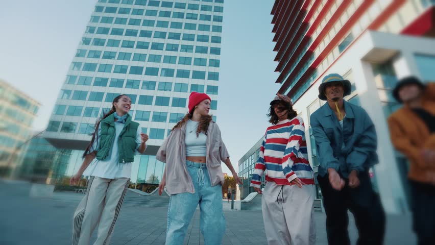 Young urban dancers perform in the city surrounded by modern skyscrapers, showcasing energy, style, and street fashion in a dynamic hip hop choreography