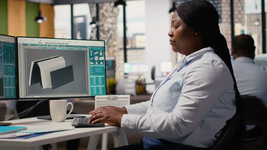 Engineer in office develops innovative solar powered device using advanced materials and designs. RD department expert creating solar gadget to improve environmental conservation efficiency, camera B