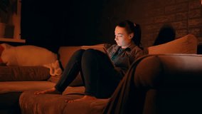 Focused Caucasian woman working from home sitting on a sofa while using a digital tablet and stylus to create detailed drawings. Freelance designer is deeply concentrated on sketching and illustrating - Powered by Shutterstock - Get 15% off with code: PIKWIZARD15