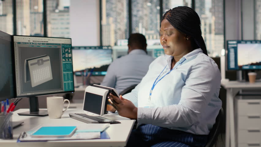 Engineer in office testing innovative solar powered device, turning lights on. RD expert doing trial of portable solar panel gadget to improve environmental conservation efficiency, camera B