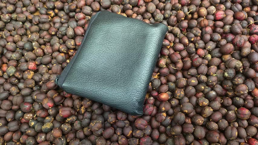 black wallet with raw coffee background