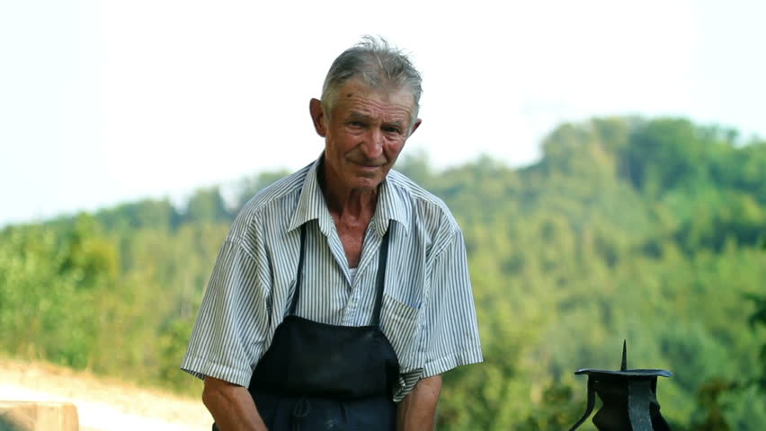 Older man working in front of his house
