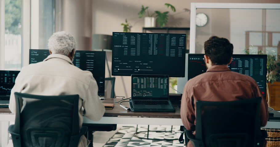 Businessmen, stock market and discussion computer in office for company finance or investment. Back view, male people or broker with technology, screen or cryptocurrency for trading app in workplace