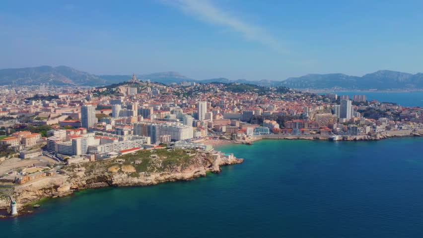 aerial view showcases the vibrant cityscape of Marseille, France, stretching along the stunning Mediterranean coastline.