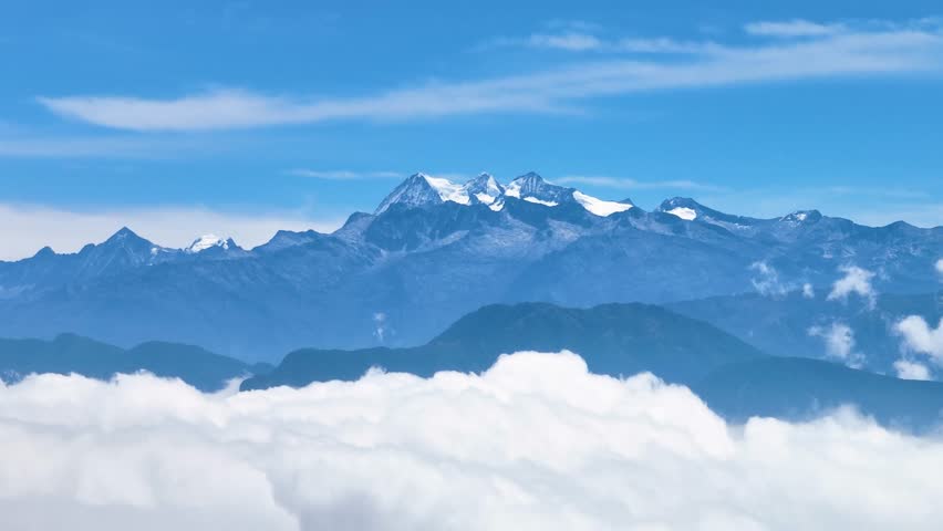 Drone view of the snowy peaks of Sierra Nevada de Santa Marta in Colombia, towering above the clouds, one of the highest coastal mountain ranges on Earth