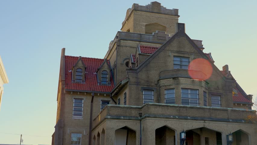 A panning shot with lens flares of the historic Old Hanging Jail in DeRidder, Louisiana. It is a historic site rumored to be haunted.