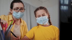 Teaching and learning at home together using laptop and pencil while mother guides daughter wearing mask during study session parent and homeschool teacher support child learning online practice - Powered by Shutterstock - Get 15% off with code: PIKWIZARD15