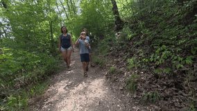 Family walking on a forest trail. Woman and two children enjoy a summer hike, one boy blowing soap bubbles while exploring nature, leisure, outdoor activity, and bonding time together - Powered by Shutterstock - Get 15% off with code: PIKWIZARD15