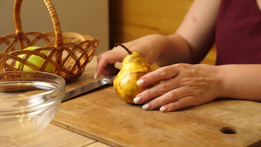 Peel the pear and cut it into pieces.