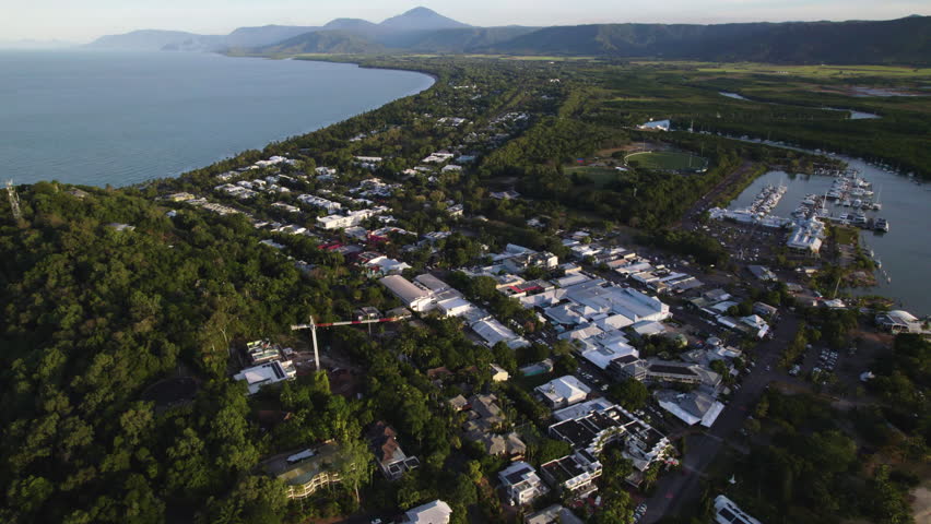 Aerial view overlooking the Port Douglas town and the shore, sunset in Australia