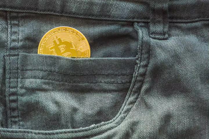Video of a golden Bitcoin in a jeans coin pocket