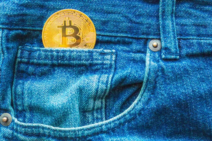 Video of a golden Bitcoin in a jeans coin pocket