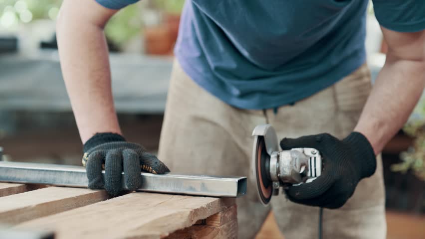 Grinding of welded joints. A man is processing a metal product with an angle grinder, close-up.