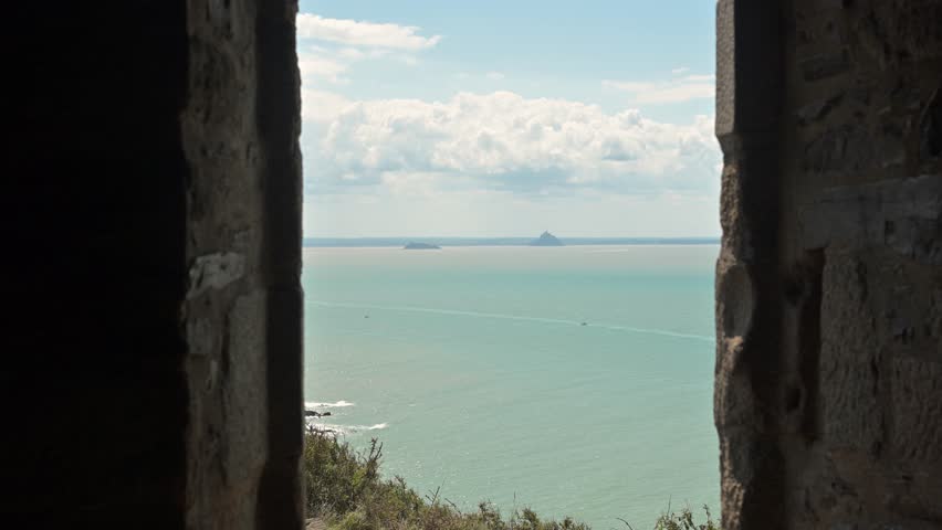Mont Saint-Michel appears on the horizon from within Carol’s cabane, combining Normandy’s coastal heritage and natural scenery.