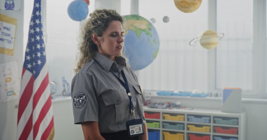 American Female Policewoman in Uniform Visiting Primary School Classroom, Giving Lecture to Curious Students About Safety Rules. Police Officer Teaching Children About Discipline, Law and Protection.