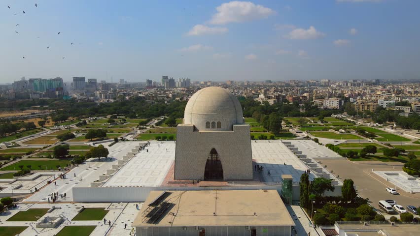 Aerial view of the white marble mausoleum, Mazar-e-Quaid, stands out amidst the lush greenery and urban landscape, Karachi, Sindh, Pakistan.