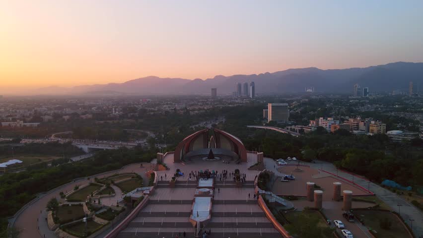 Aerial view of the Pakistan Monument atop Shakarparian Hills, with the city buildings in the background, at dusk, Islamabad, Islamabad Capital Territory, Pakistan.