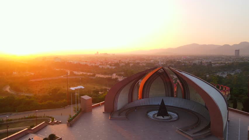 Aerial view of the Pakistan Monument in Islamabad, with a beautiful sunrise casting warm light over the city, Islamabad, Islamabad Capital Territory, Pakistan.