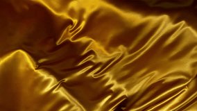 Super Slow Motion of Waving Golden Satin Cloth. Filmed on High Speed Cinema Camera, 1000 fps. Isolated on White Background. - Powered by Shutterstock - Get 15% off with code: PIKWIZARD15