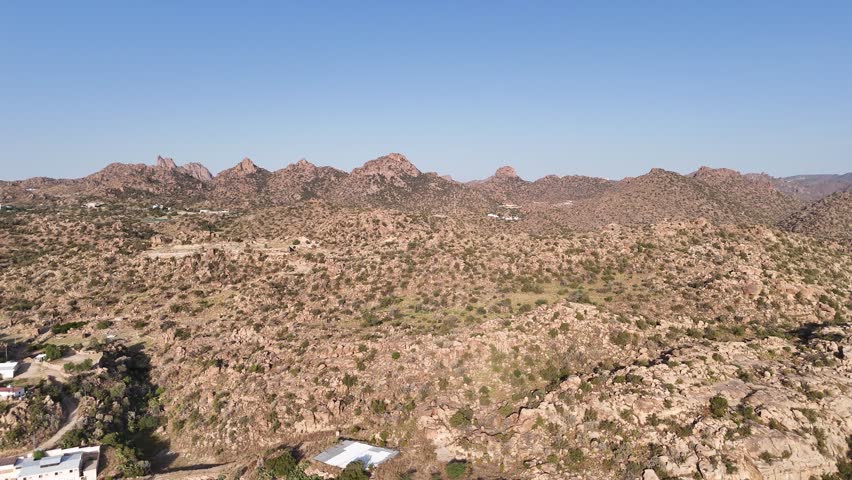 Aerial overview of mountainous, rocky landscape, sunny day in Taif, Saudi Arabia