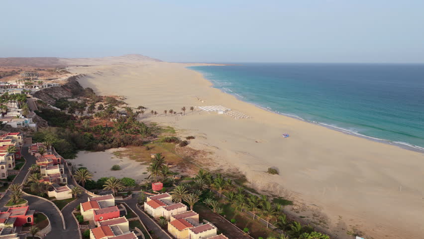 Aerial view of of sandy beach,parasol, turquoise ocean and luxury resort at Praia de Chaves (Chaves beach), Boa Vista, Cabo Verde (Cape Verde)
