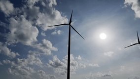 Wind Energy Under the Sun: Capturing the majestic dance of wind turbines against a radiant sun, harnessing clean power in harmony with nature, symbolizing progress and sustainability. - Powered by Shutterstock - Get 15% off with code: PIKWIZARD15