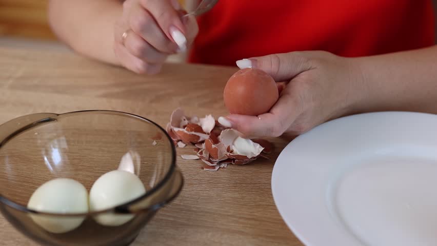 Peeling a boiled egg. Preparing dishes with eggs.