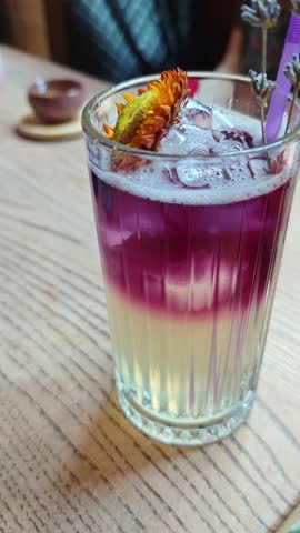 Refreshing lavender lemonade served in a glass with ice and herbs. Summer drink scene symbolizing freshness, relaxation, natural lifestyle, and homemade beverage.