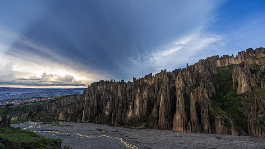 Time lapse scene of dramatic rock formations under colorful evening sky in Valle de las Animas, Bolivia, a unique and rugged geological landscape.