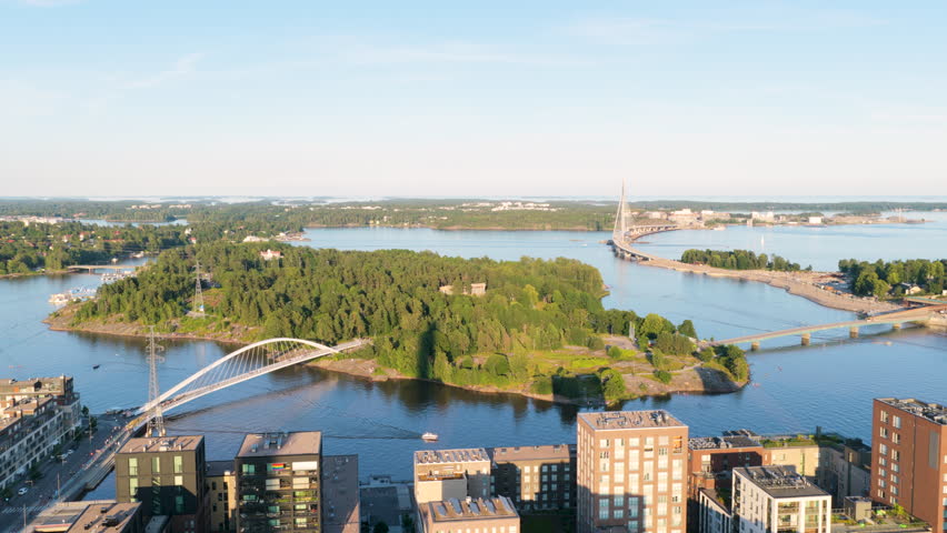 Aerial view circling the Mustikkamaa island, golden hour in Helsinki, Finland