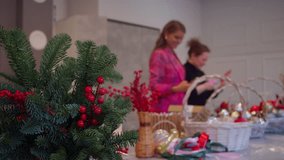 Girlfriends enjoy spending time together during workshop on making Christmas wreaths from fir branches and decorating for upcoming New Year. They communicate and take pictures while working. - Powered by Shutterstock - Get 15% off with code: PIKWIZARD15