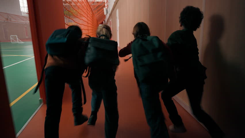 Back view four multiracial children running in school group of active diverse kids classmates little friends run in corridor hurrying to class come in classroom elementary education friendship concept